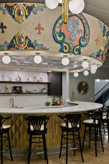 Kitchen island with ornate ceiling mural and gold accents